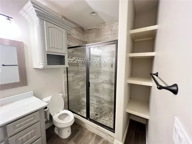 a bathroom with a sink mirror and toilet