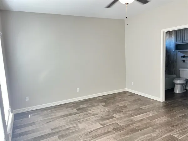 a view of wooden floor and windows in a room