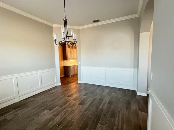 a view of a room with wooden floor ceiling fan and window