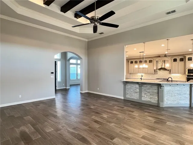 a view of an empty room with a kitchen