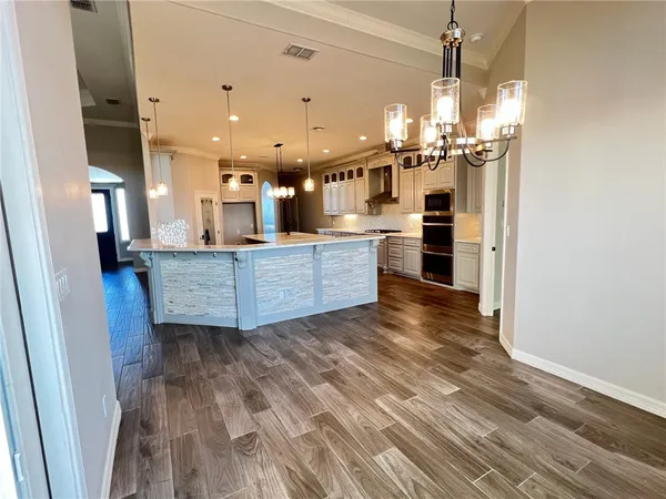 a open kitchen with a refrigerator and a stove
