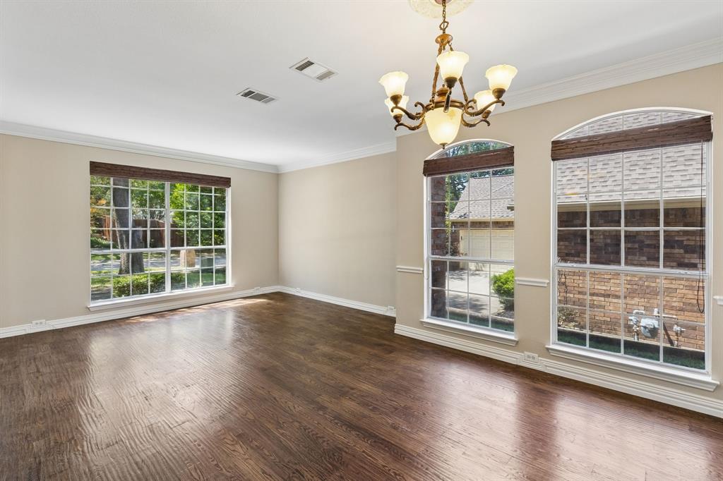 2925 Sunset Ridge McKinney, TX 75072 - Photo 5 of 33 Spacious formal living and dining area filled with natural light from oversized windows, offering beautiful hardwood flooring and a versatile layout ideal for entertaining or everyday living.