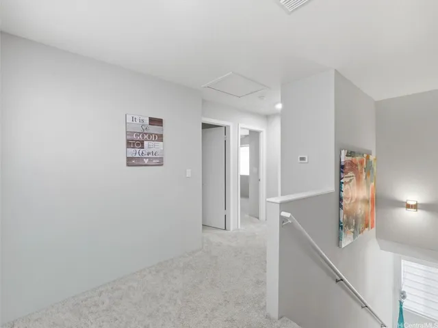 a view of a hallway with paintings on the wall