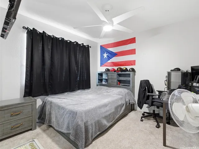 a bed room with a bed and a chair