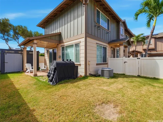 a view of a house with a yard and sitting area