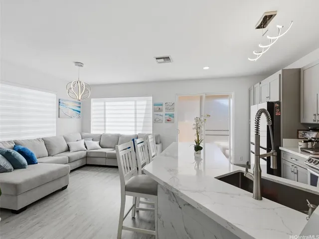 a living room with furniture wooden floor and a flat screen tv