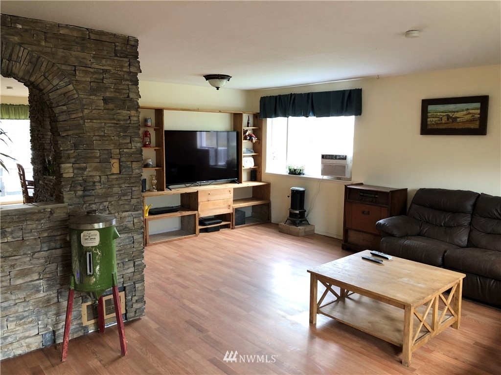 11020 Independence Road Southwest Rochester, WA 98579 - Photo 23 of 38 a living room with furniture and a flat screen tv