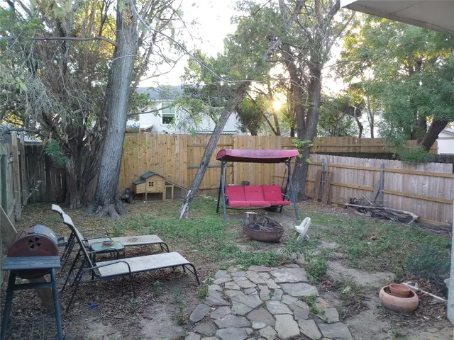 a view of a backyard with sitting area