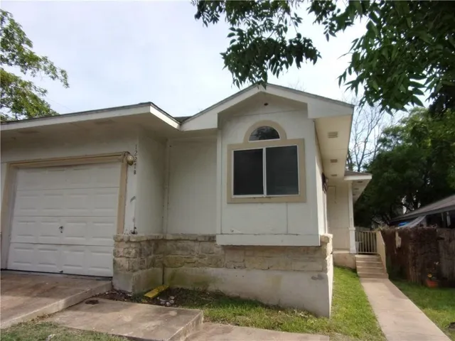 a front view of a house with garage