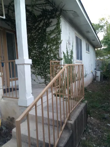 a view of balcony with wooden floor and fence