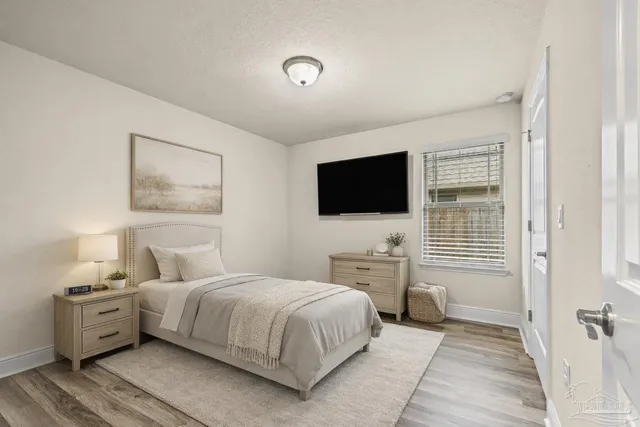 a bedroom with a bed and a flat screen tv