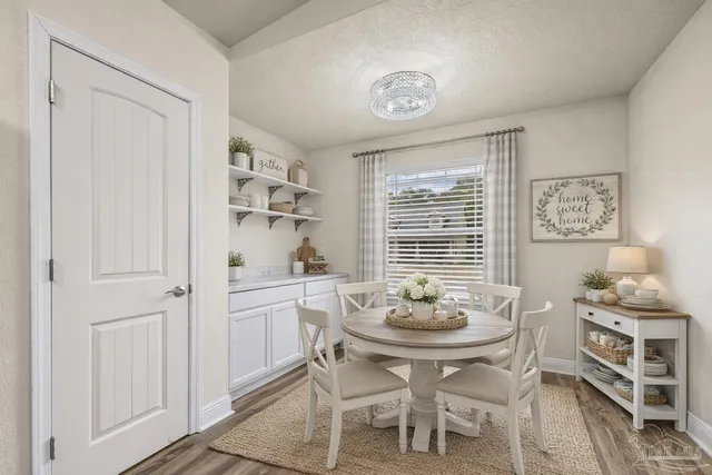a dining room with furniture and window
