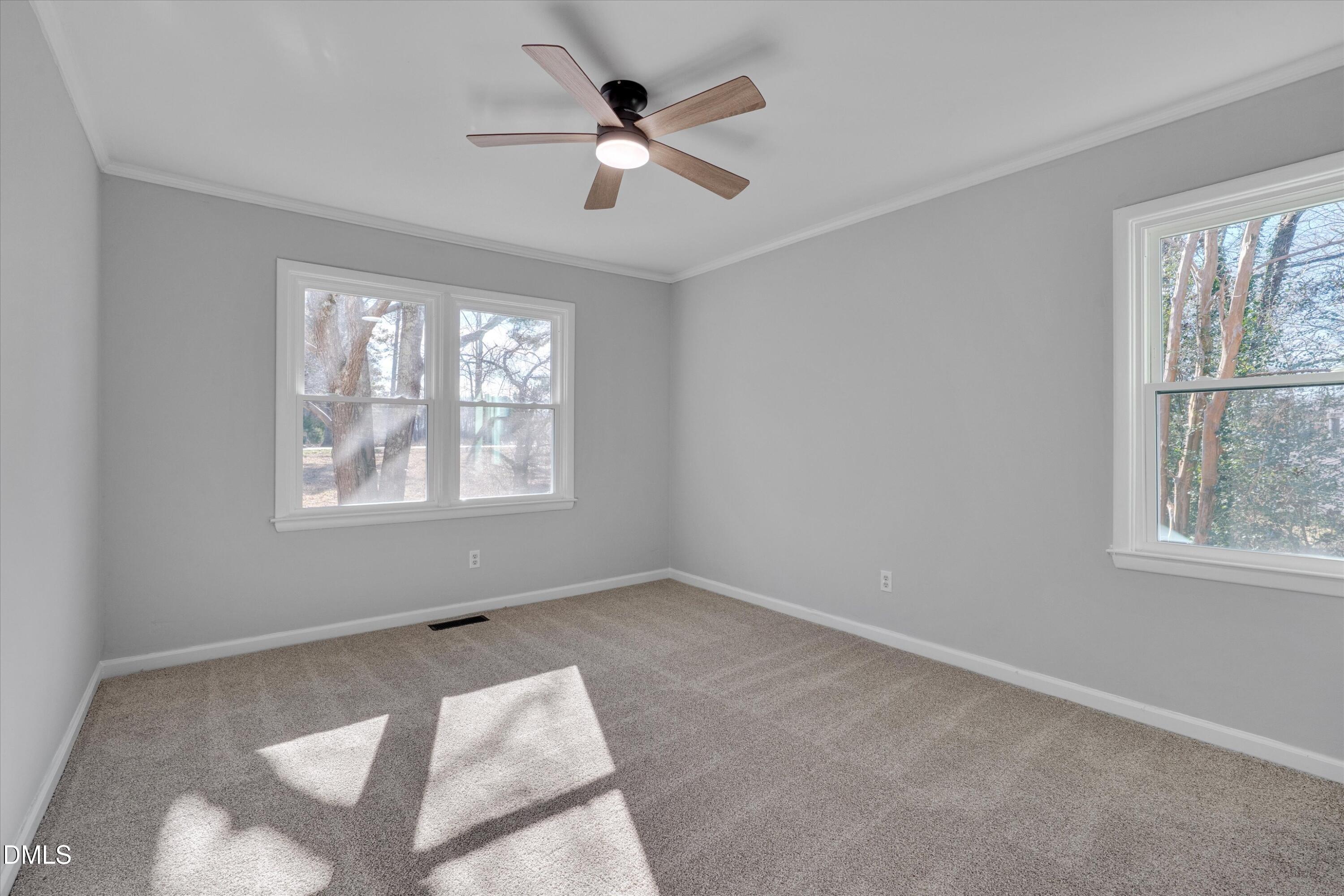 2728 South Cokesbury Road Henderson, NC 27537 - Photo 20 of 40 an empty room with windows and ceiling fan