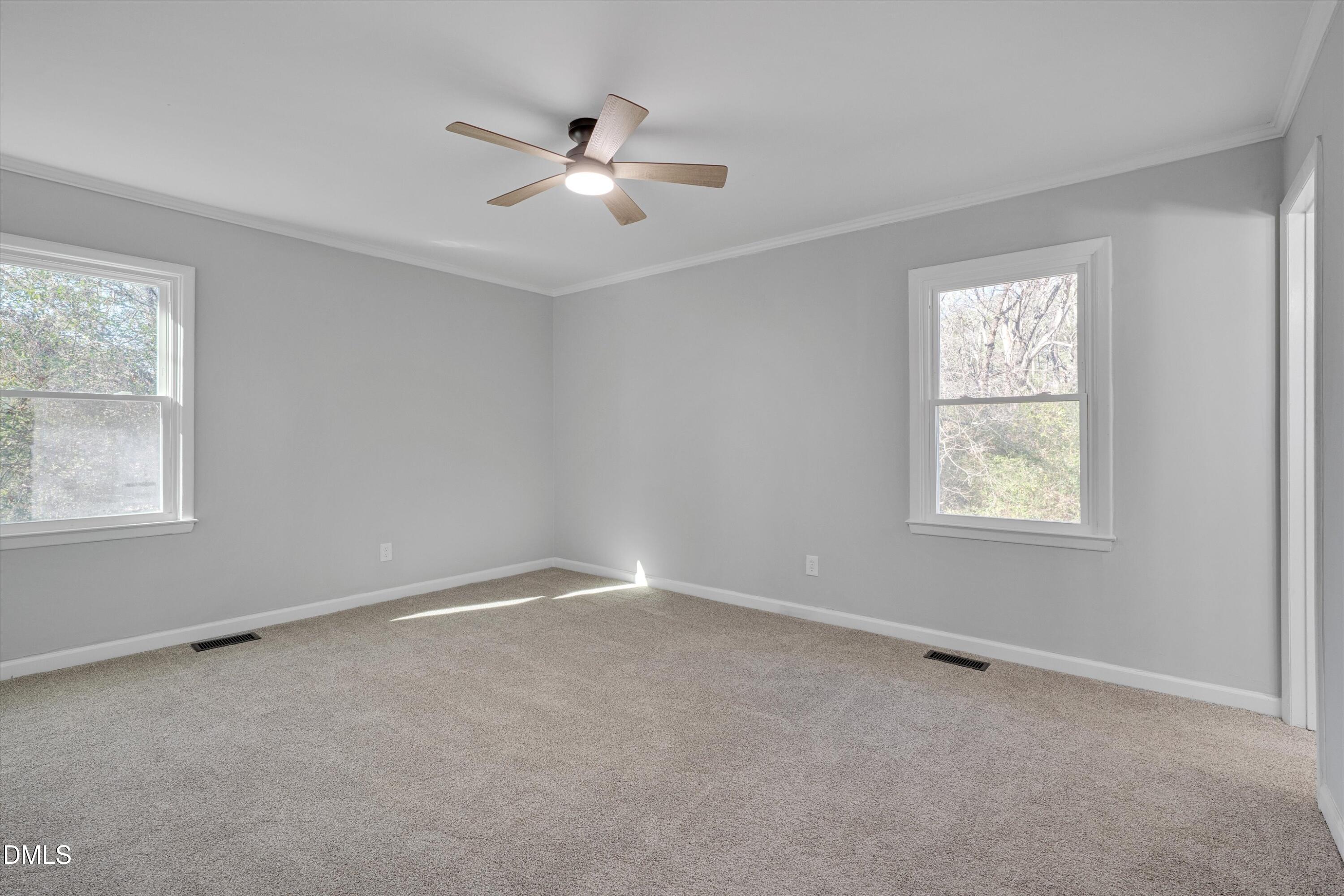 2728 South Cokesbury Road Henderson, NC 27537 - Photo 21 of 40 an empty room with windows and fan