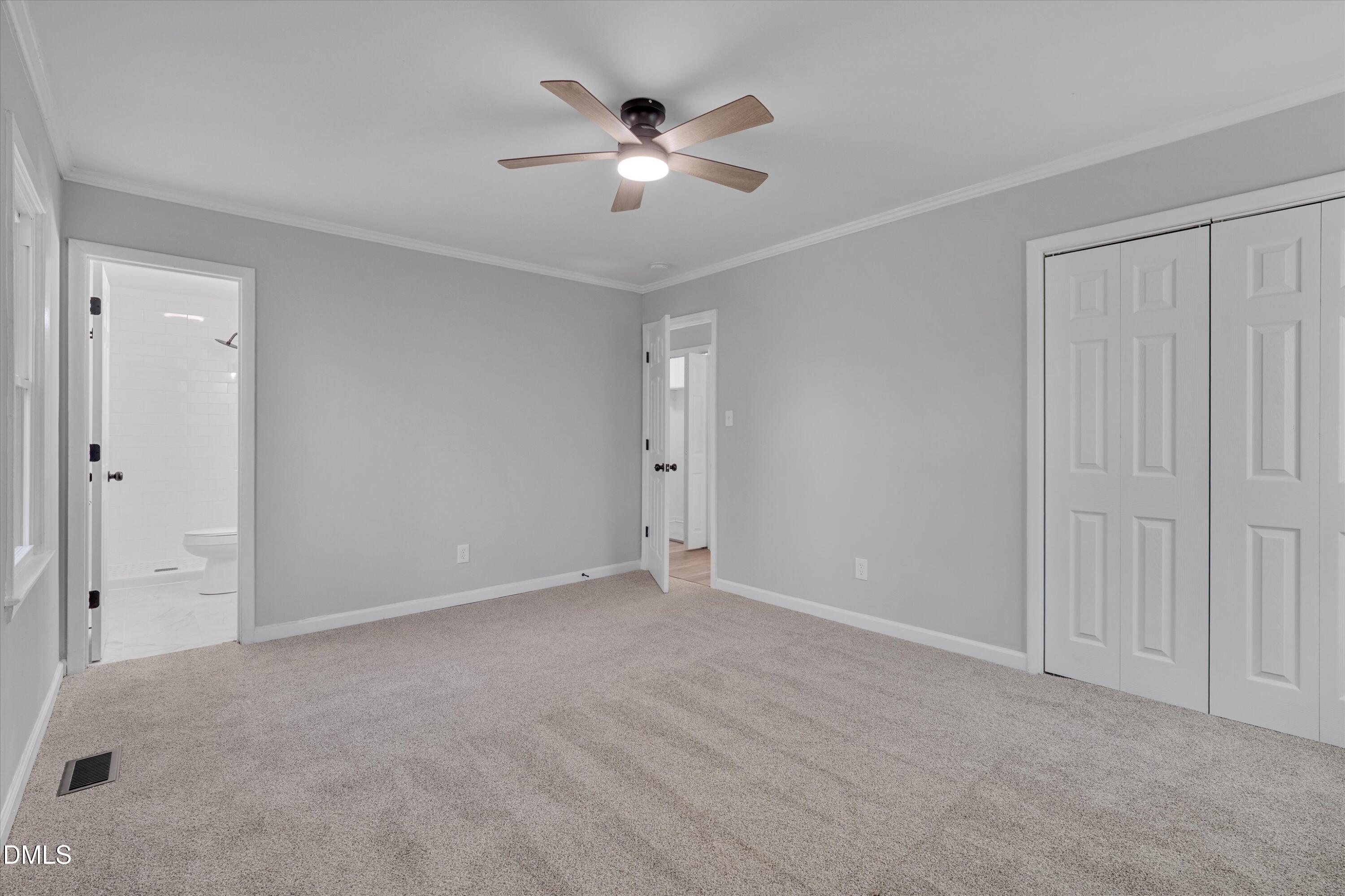 2728 South Cokesbury Road Henderson, NC 27537 - Photo 22 of 40 an empty room with closet and a ceiling fan