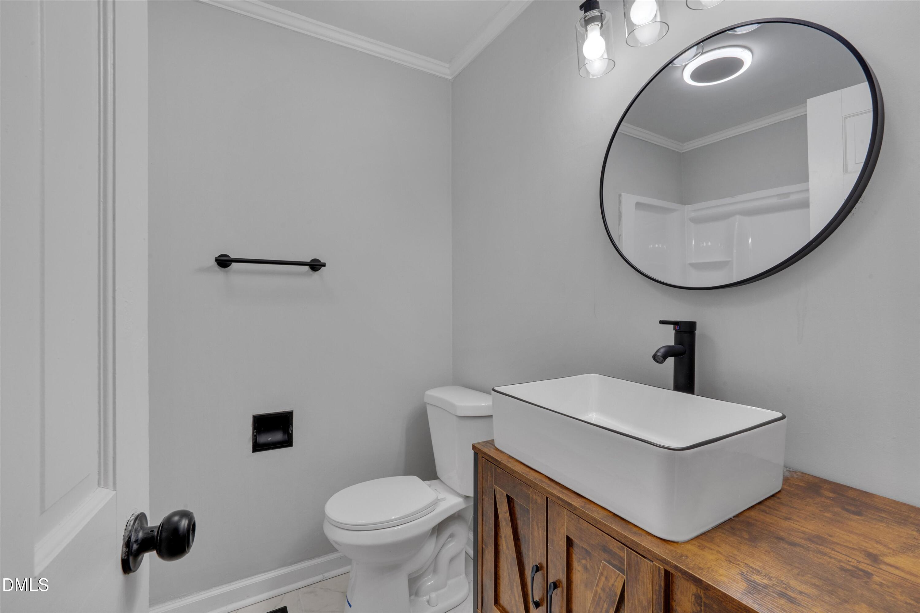 2728 South Cokesbury Road Henderson, NC 27537 - Photo 27 of 40 a bathroom with a sink and a mirror