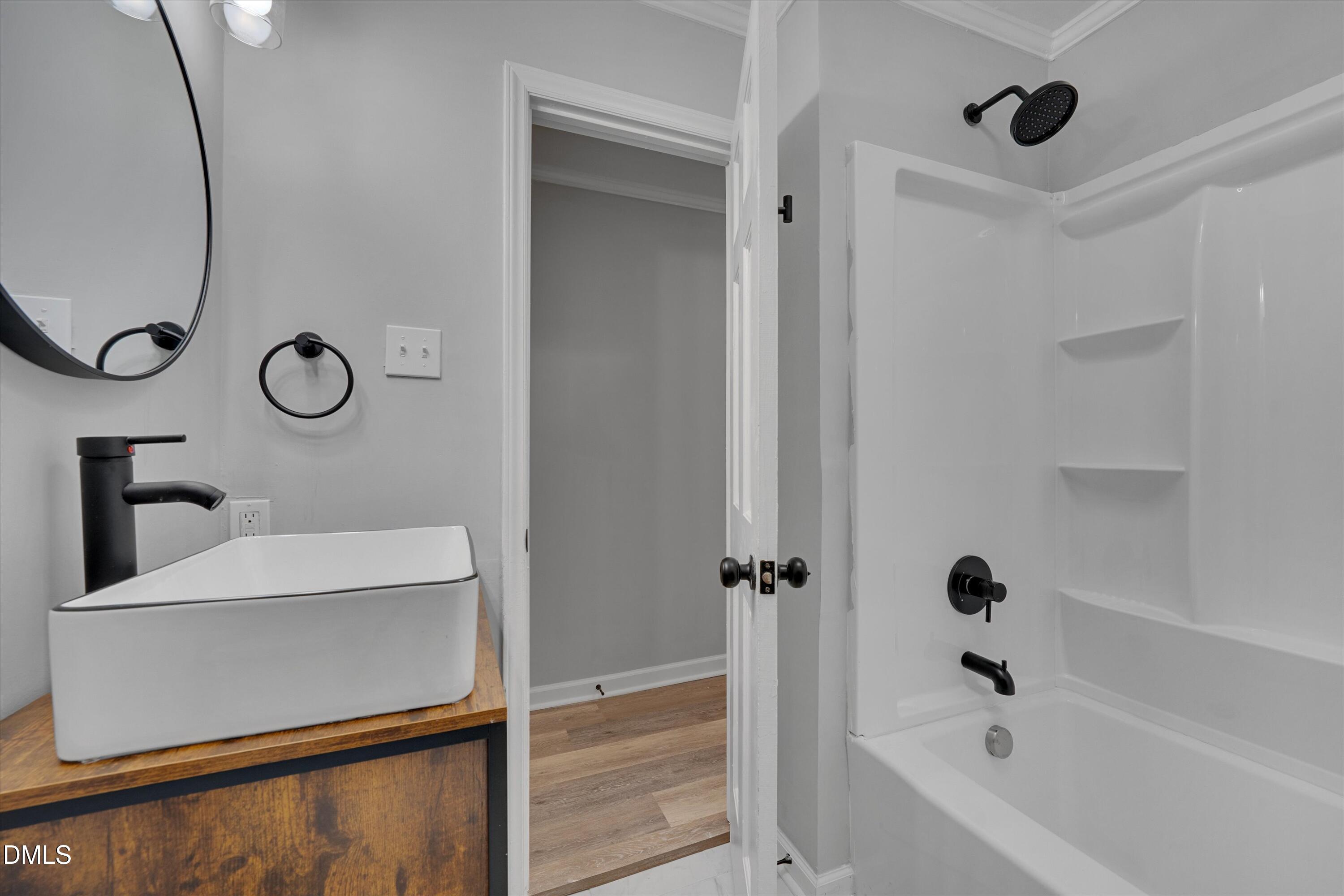 2728 South Cokesbury Road Henderson, NC 27537 - Photo 28 of 40 a bathroom with a tub sink and mirror