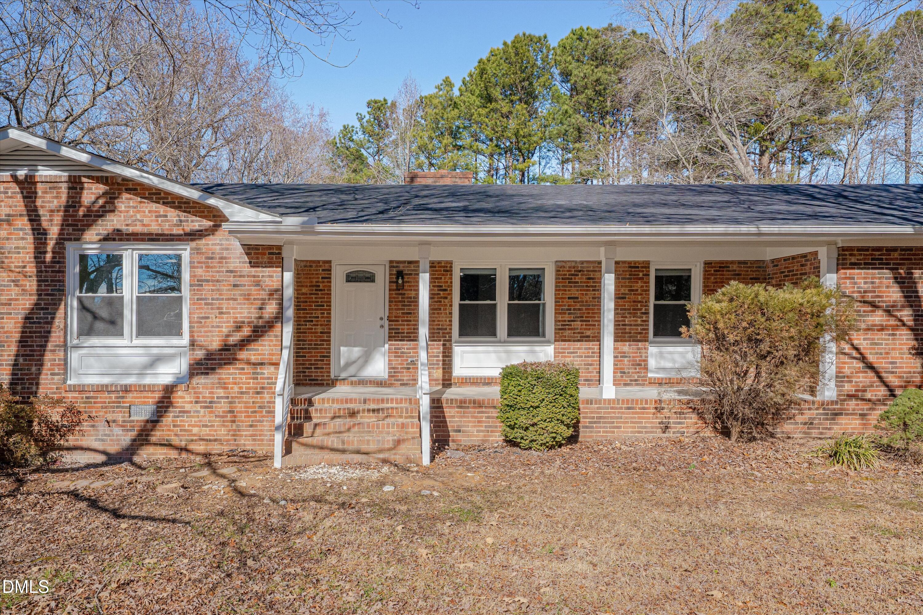 2728 South Cokesbury Road Henderson, NC 27537 - Photo 2 of 40 a front view of a house with garden