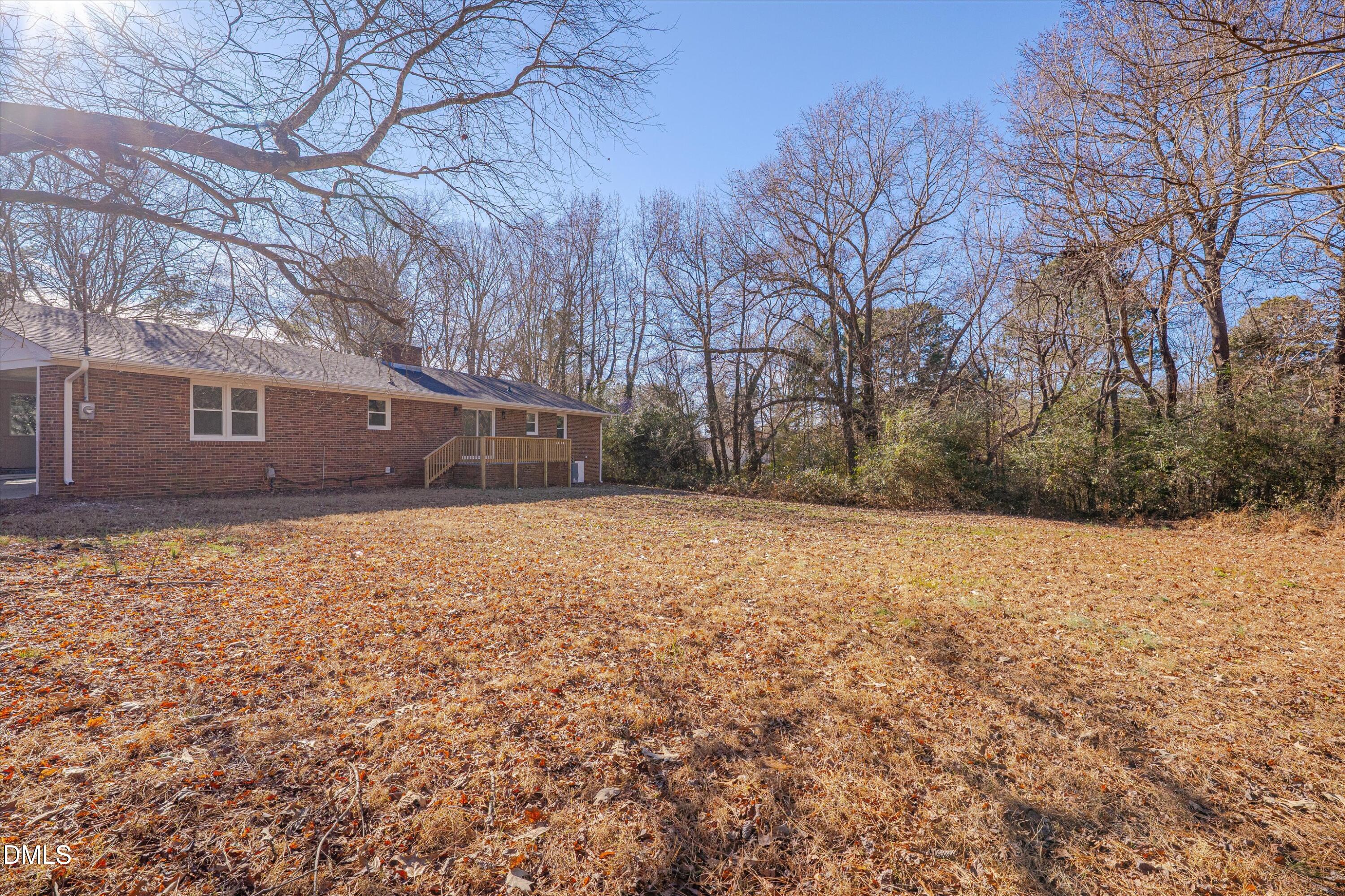 2728 South Cokesbury Road Henderson, NC 27537 - Photo 31 of 40 a backyard of a house with large trees