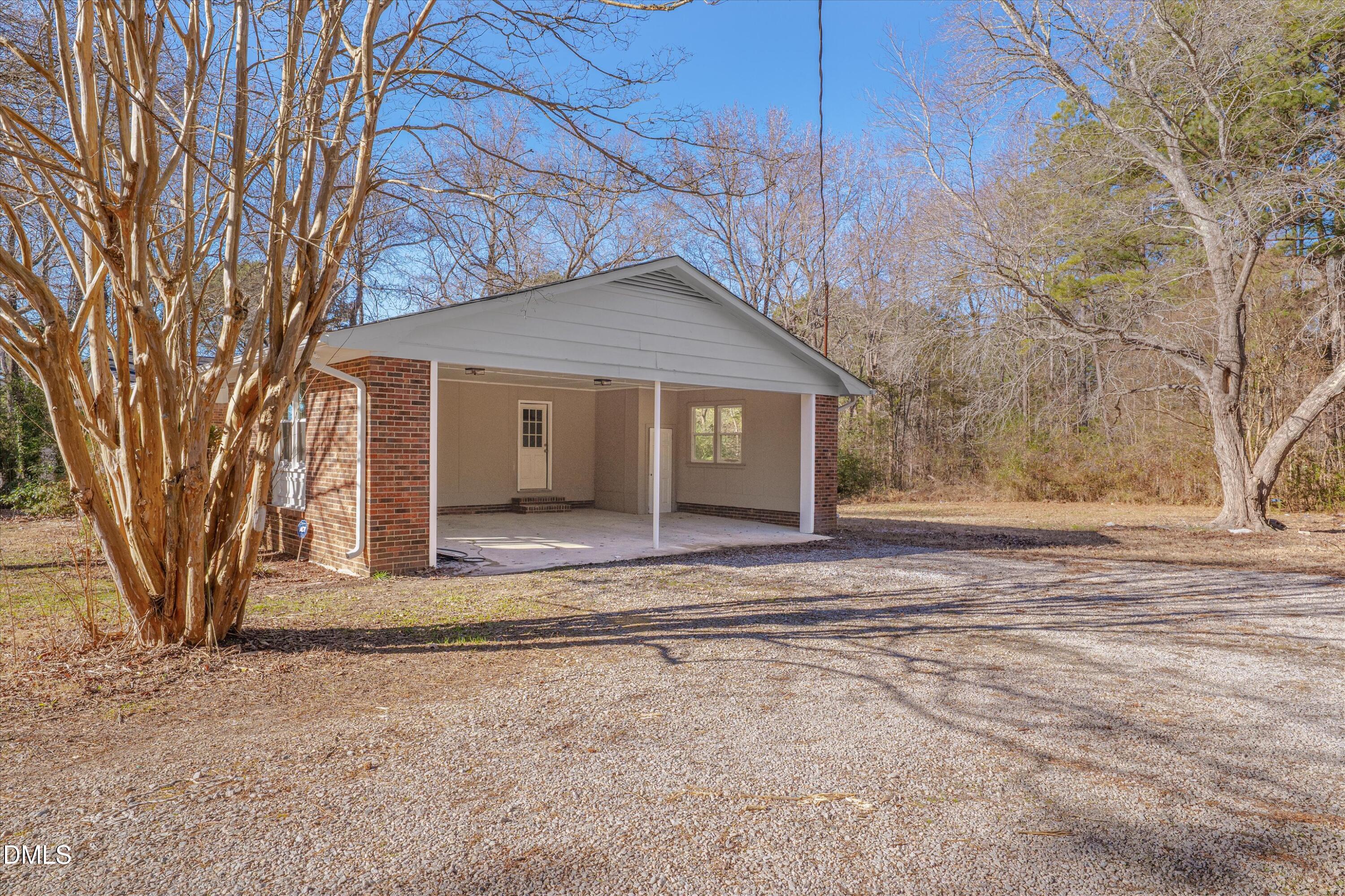 2728 South Cokesbury Road Henderson, NC 27537 - Photo 33 of 40 a view of a house with a large tree and a yard