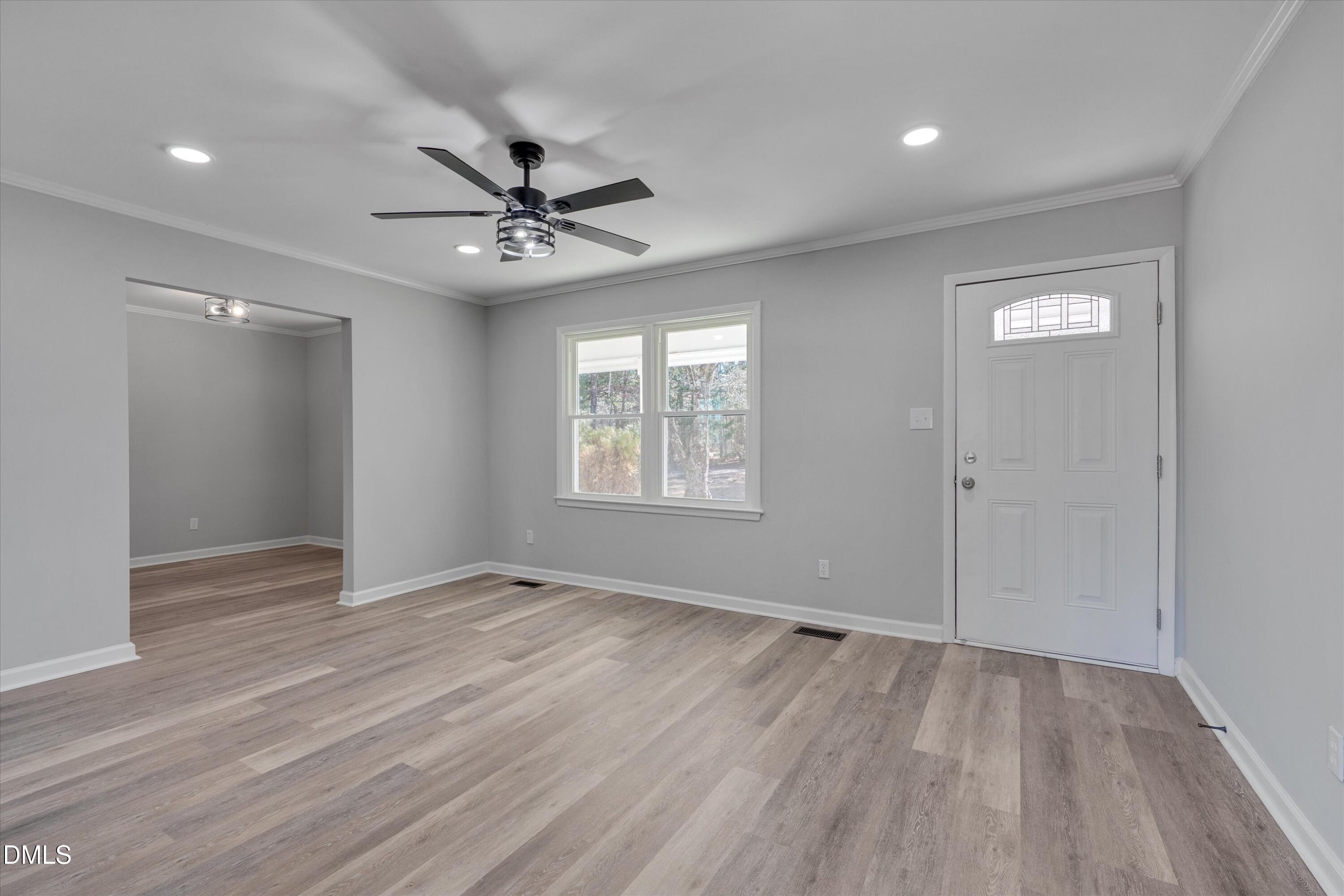 2728 South Cokesbury Road Henderson, NC 27537 - Photo 5 of 40 wooden floor in an empty room with a window