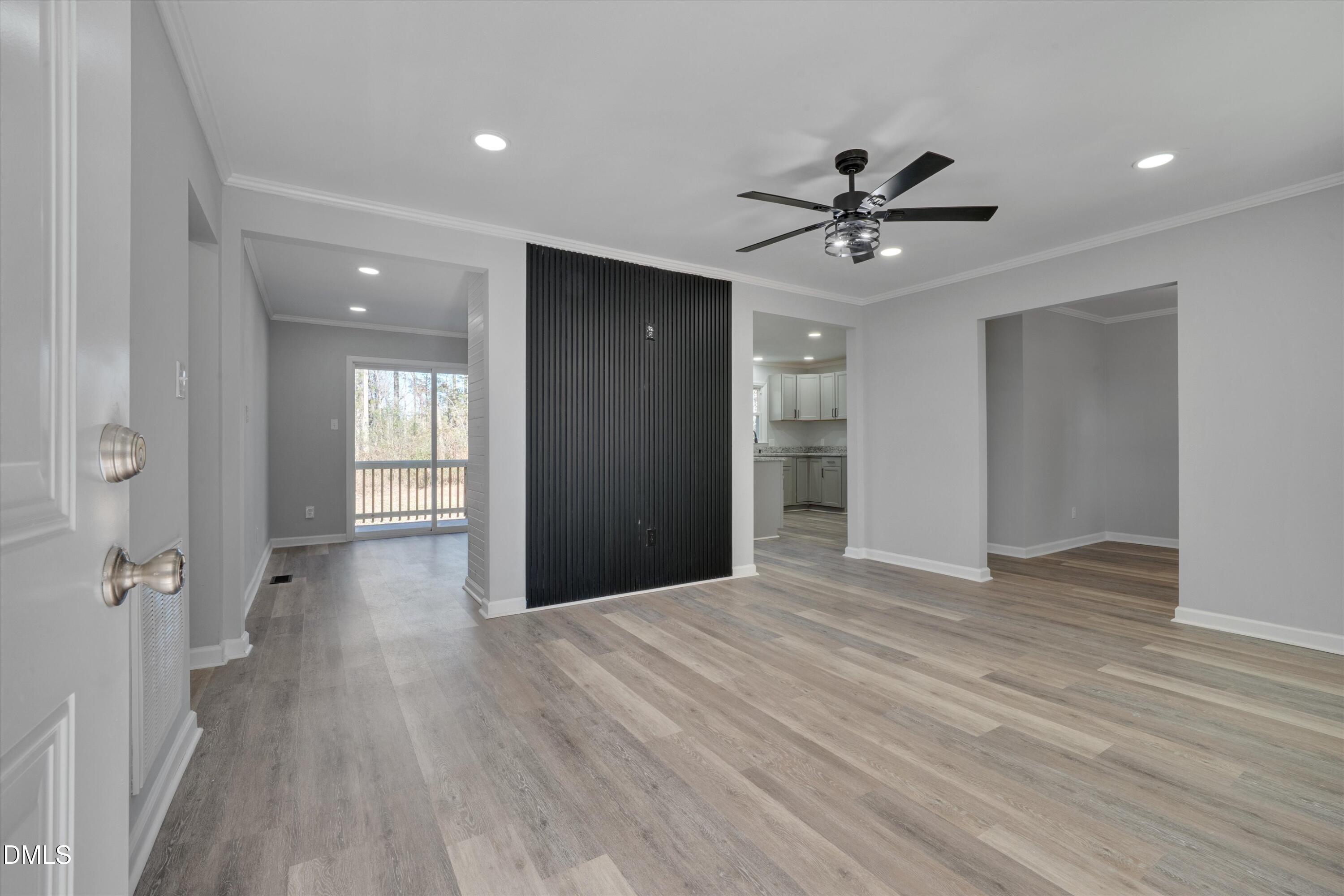 2728 South Cokesbury Road Henderson, NC 27537 - Photo 8 of 40 a view of a livingroom with a ceiling fan & hardwood floor