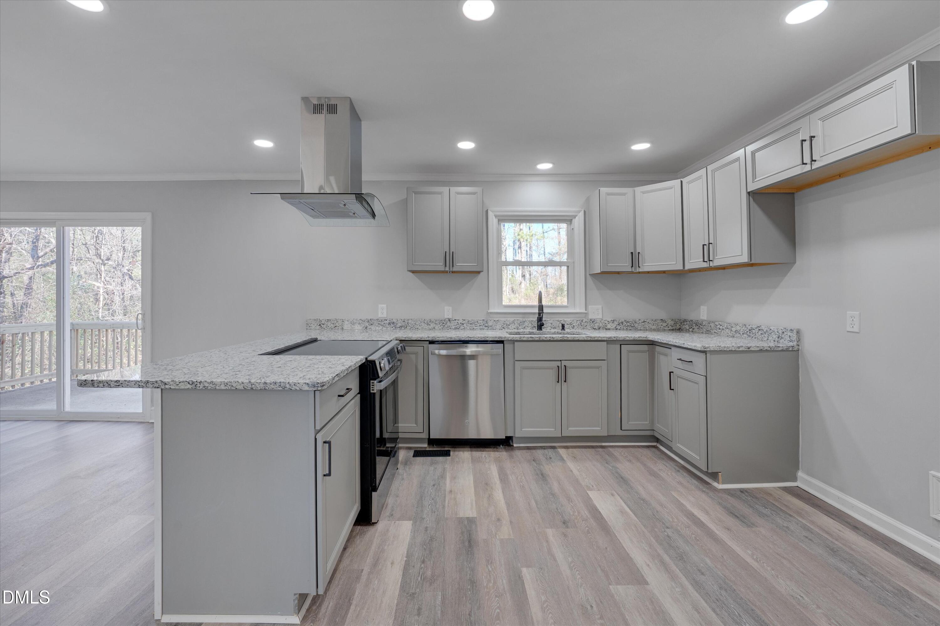 2728 South Cokesbury Road Henderson, NC 27537 - Photo 9 of 40 a kitchen with a sink window and cabinets