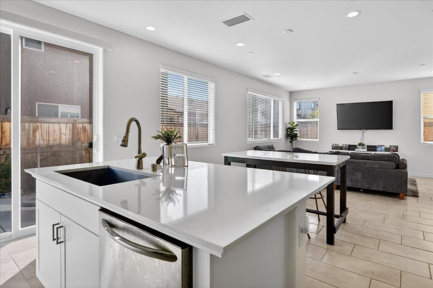 824 Katelyn Avenue Madera, CA 93636 - Photo 13 of 31 a kitchen with kitchen island a sink table and chairs