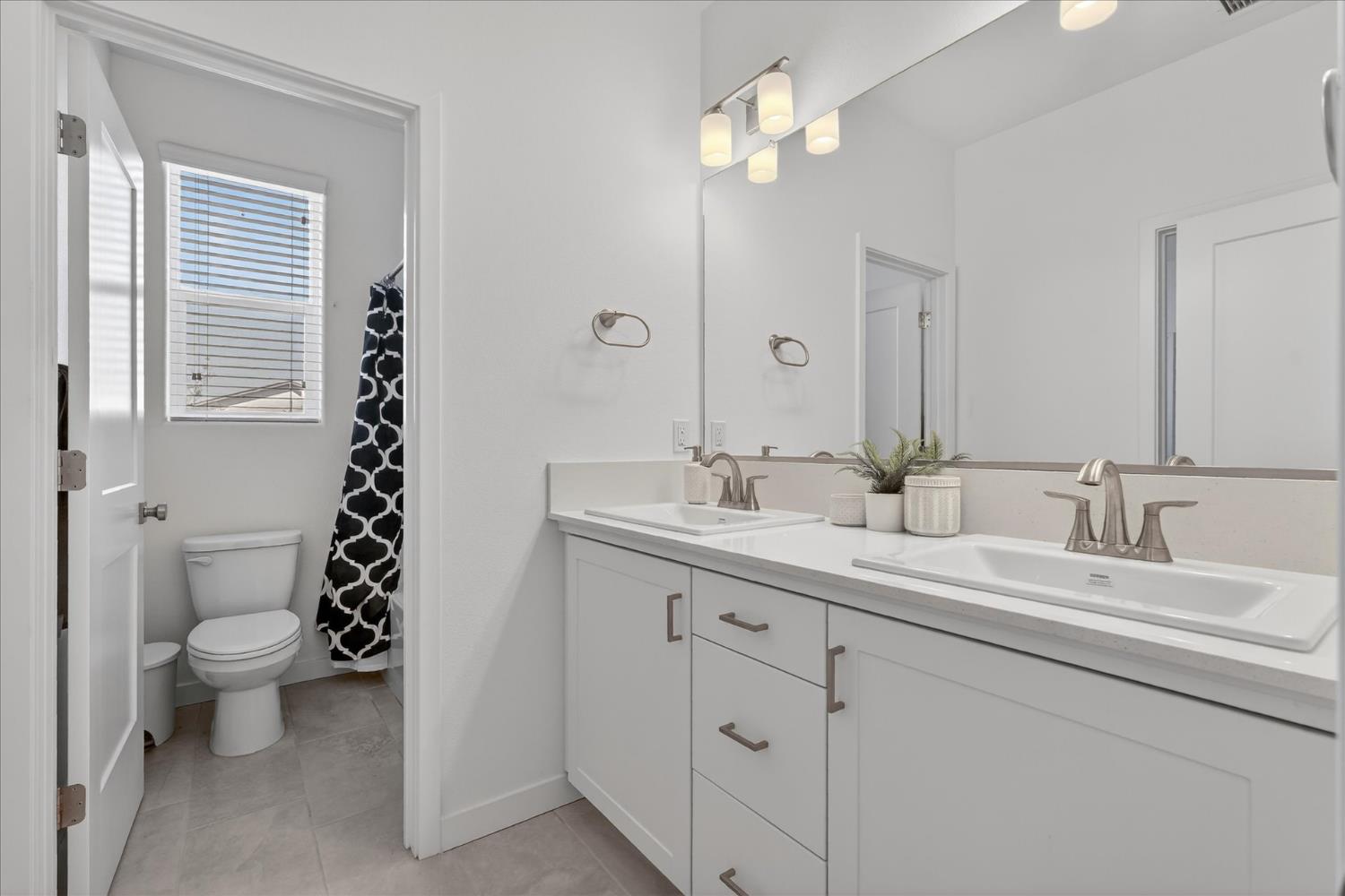 824 Katelyn Avenue Madera, CA 93636 - Photo 19 of 31 a bathroom with a double vanity sink mirror and toilet