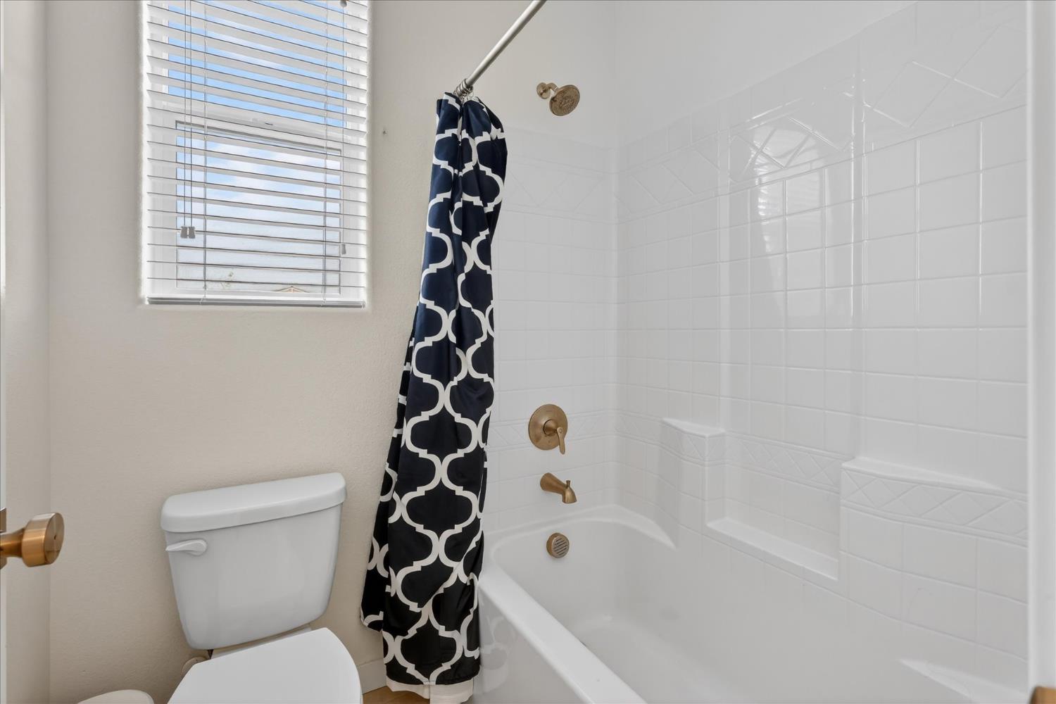 824 Katelyn Avenue Madera, CA 93636 - Photo 20 of 31 a bathroom with a toilet and shower
