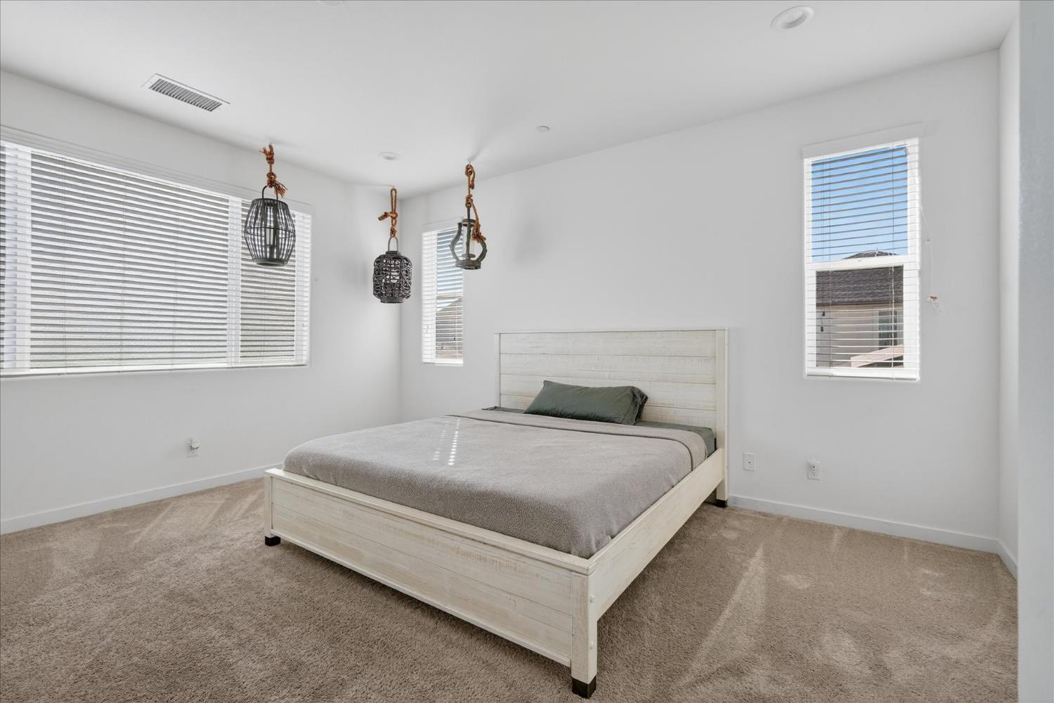 824 Katelyn Avenue Madera, CA 93636 - Photo 24 of 31 a bed sitting in a bedroom next to a window and a window