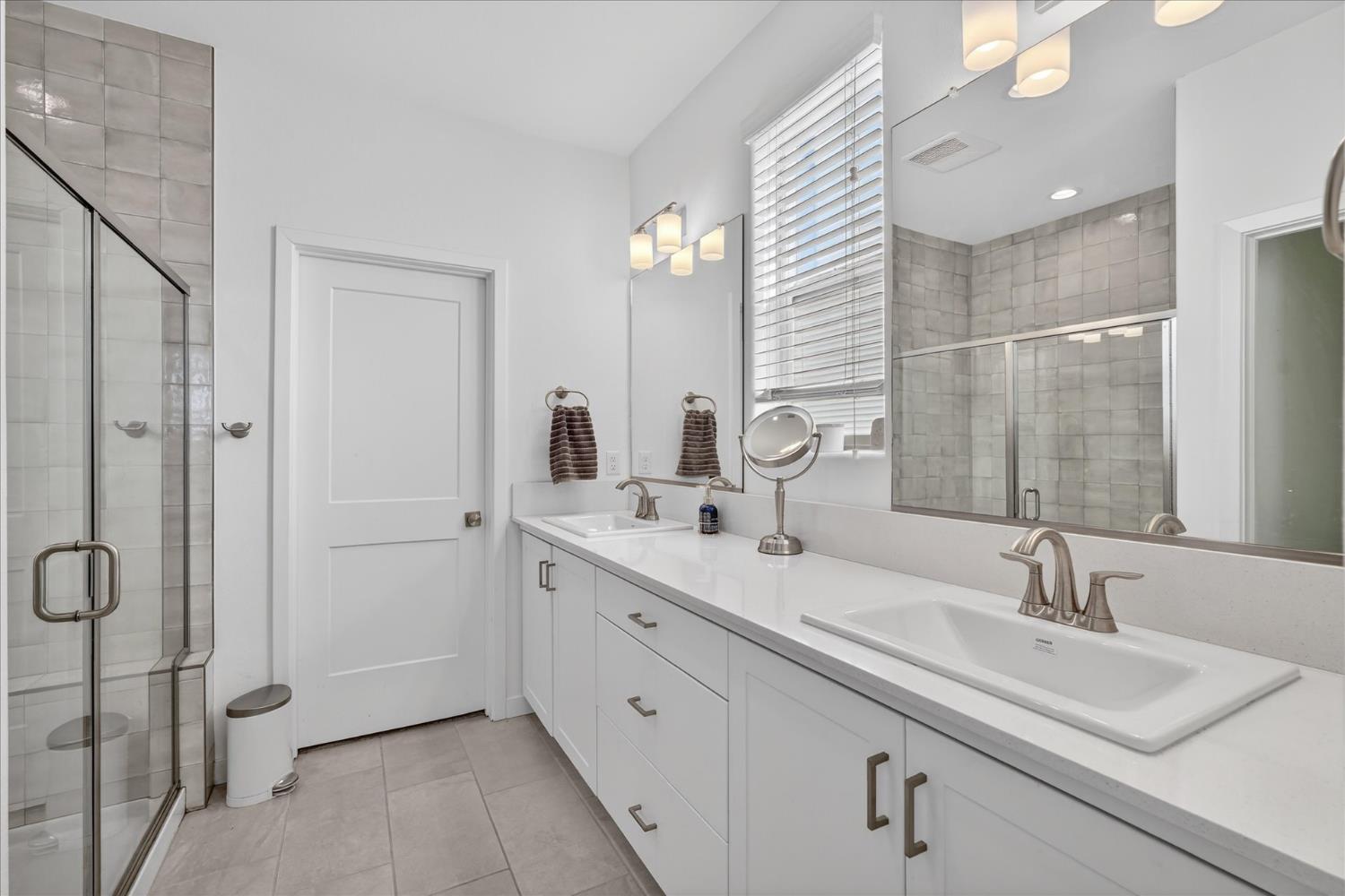 824 Katelyn Avenue Madera, CA 93636 - Photo 26 of 31 a bathroom with a double vanity sink mirror and shower