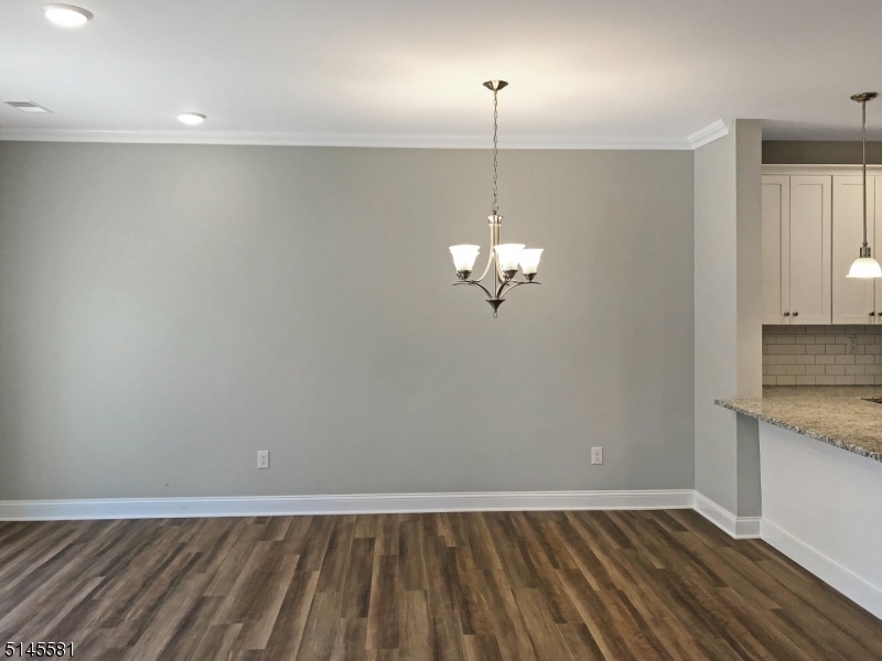 38 Old Shunpike Road, Unit A Randolph, NJ 07869 - Photo 2 of 8 a view of empty room with wooden floor and ceiling fan
