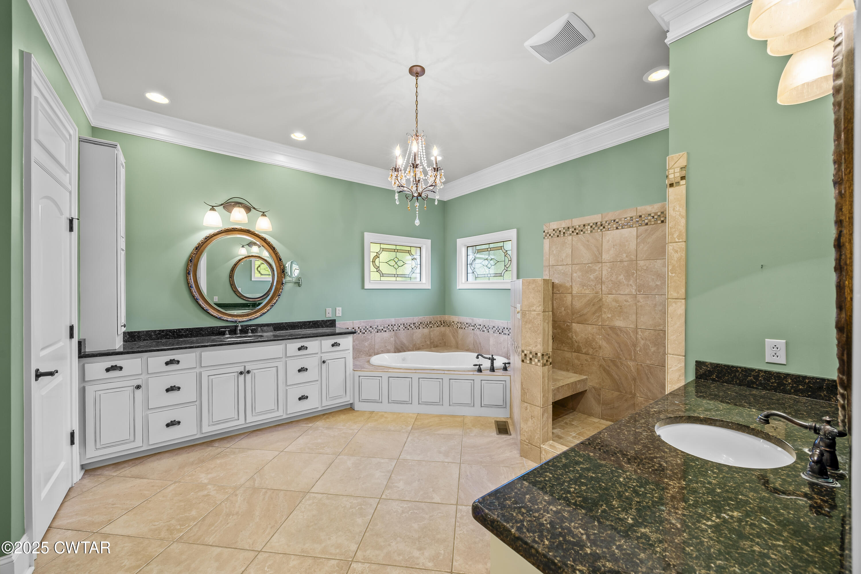 2755 Hornsby Loop Bolivar, TN 38008 - Photo 14 of 28 a spacious bathroom with a granite countertop double vanity sink a mirror and a bathtub