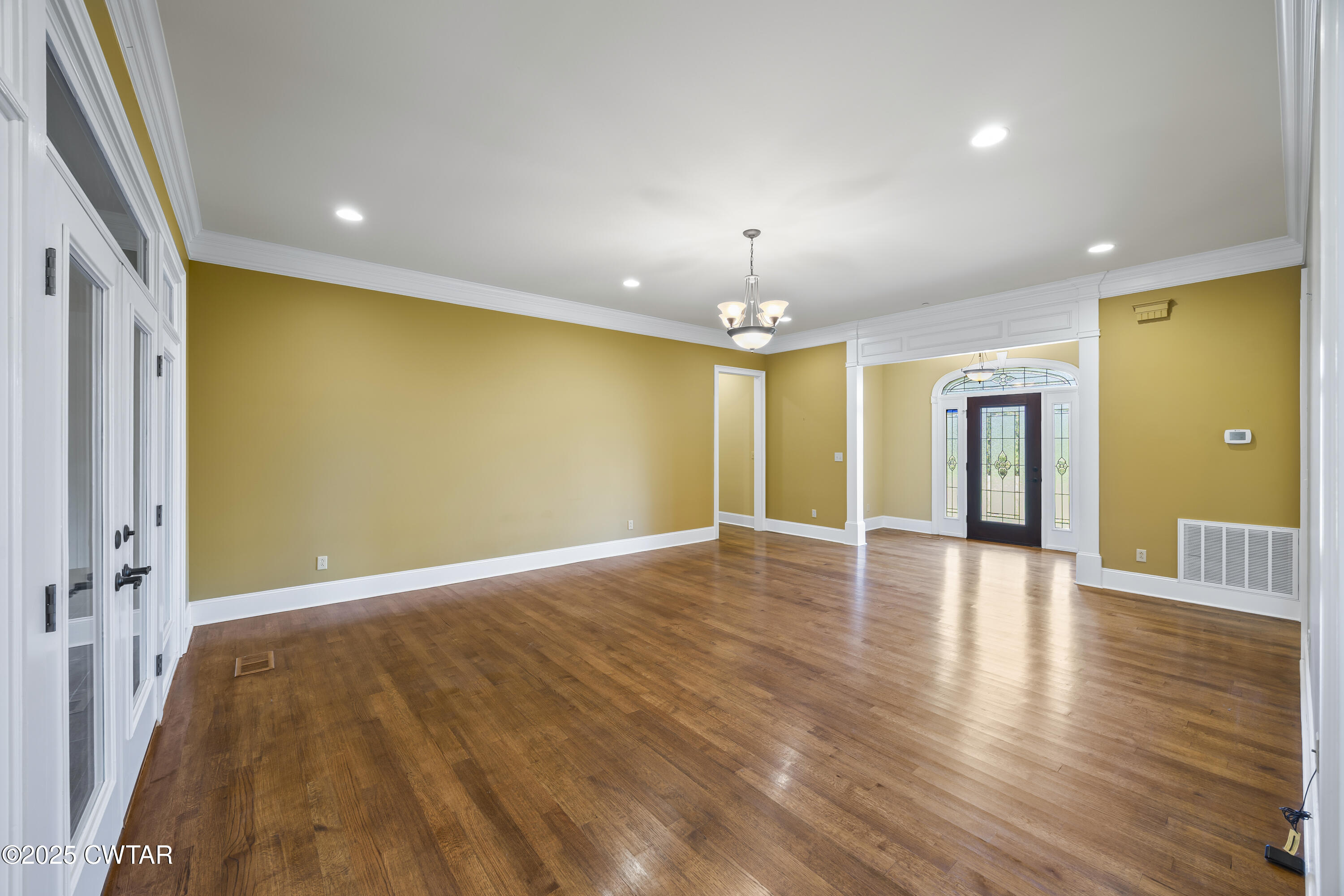 2755 Hornsby Loop Bolivar, TN 38008 - Photo 3 of 28 a view of an empty room with wooden floor and a window
