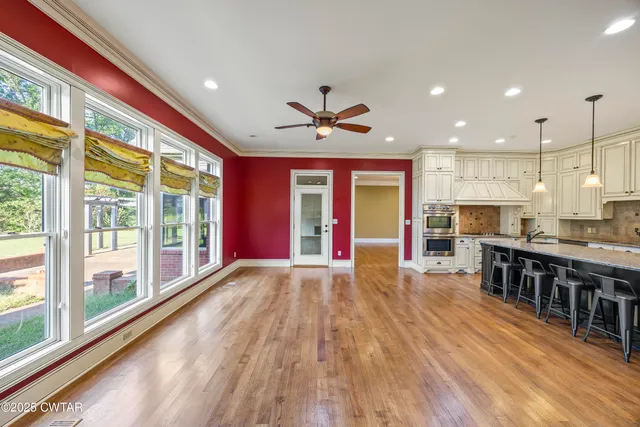 a spacious bathroom with a granite countertop double vanity sink a mirror and a bathtub