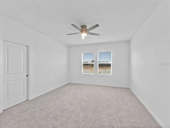 a view of a livingroom with a ceiling fan and window