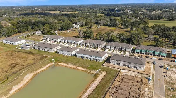 an aerial view of residential houses with outdoor space