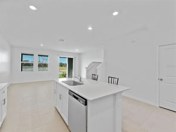 a view of kitchen island with sink and wooden floor