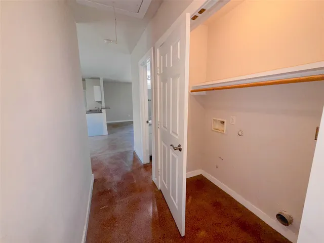 a view of a hallway with wooden floor and entryway