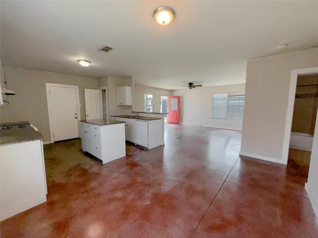 a view of a kitchen with a sink and a refrigerator