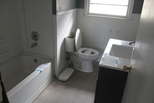 a white toilet sitting next to a bathroom sink