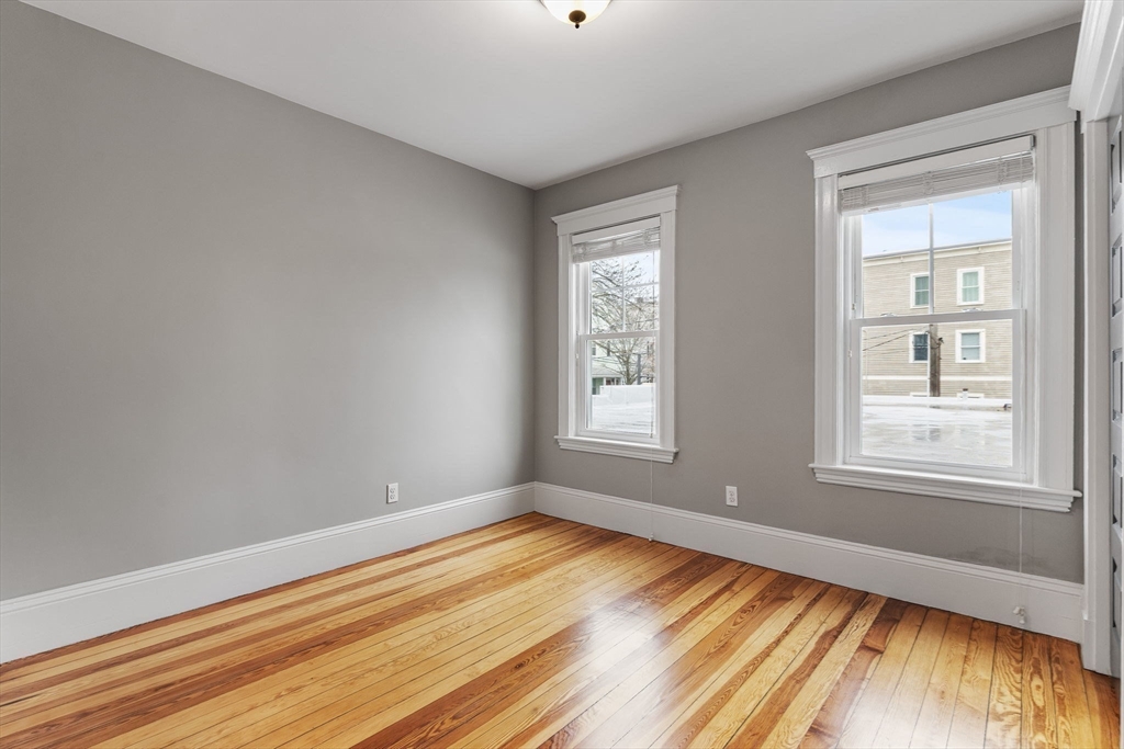 22 Clarendon Avenue, Unit 2 Somerville, MA 02144 - Photo 12 of 17 a view of empty room with wooden floor and fan