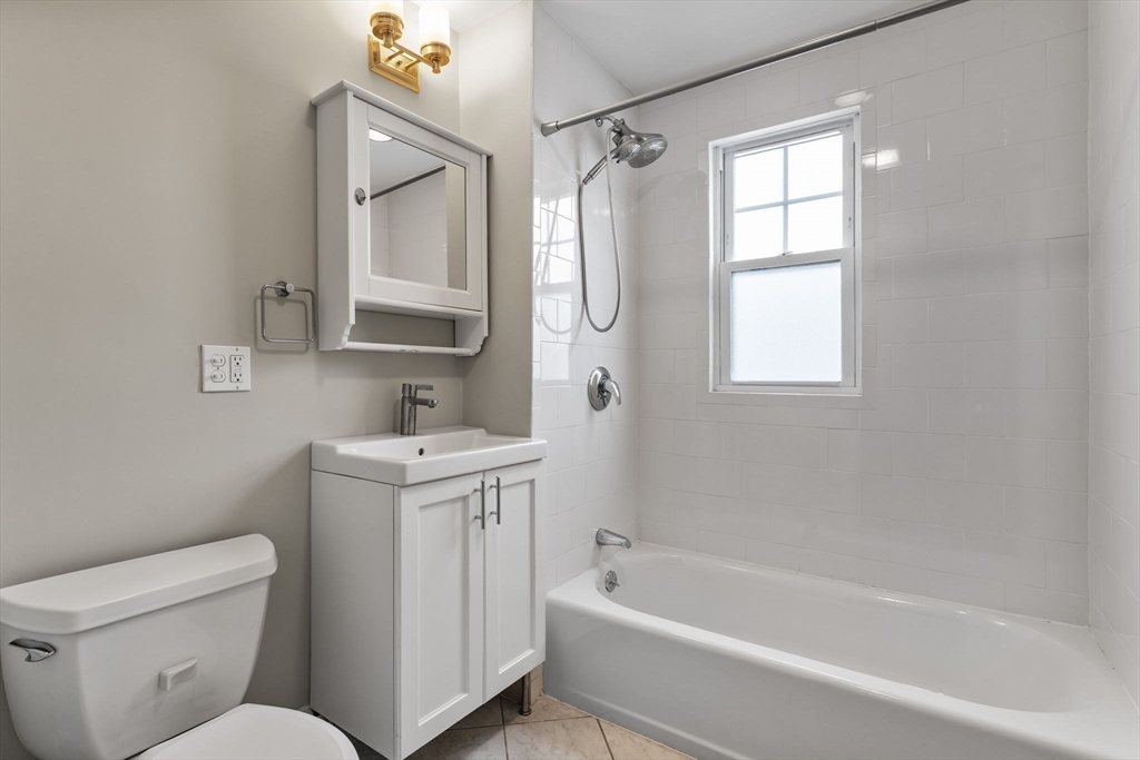 22 Clarendon Avenue, Unit 2 Somerville, MA 02144 - Photo 14 of 17 a bathroom with a sink toilet and bathtub