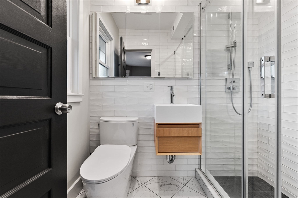 22 Clarendon Avenue, Unit 2 Somerville, MA 02144 - Photo 9 of 17 a bathroom with a toilet sink and shower