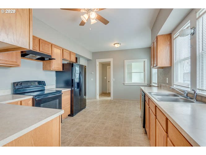 481 South Pine Street Canby, OR 97013 - Photo 6 of 17 a kitchen with stainless steel appliances granite countertop a sink stove and refrigerator