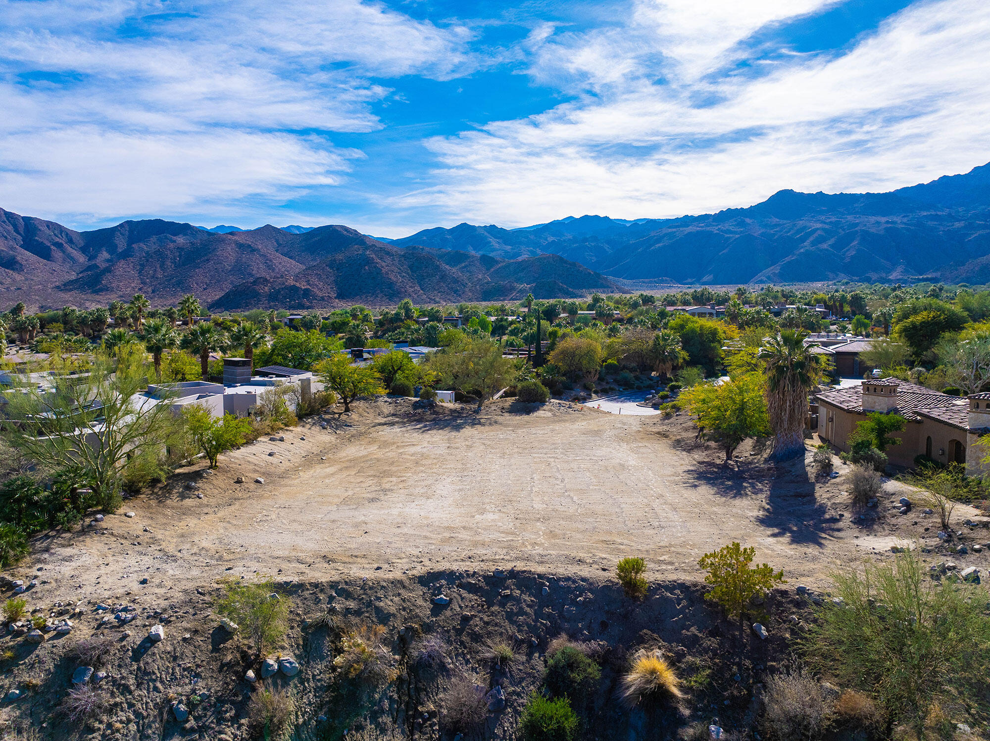 206 Palm Ridge Palm Desert, CA 92260 - Photo 3 of 14 a view of a lush green field with mountains in the background