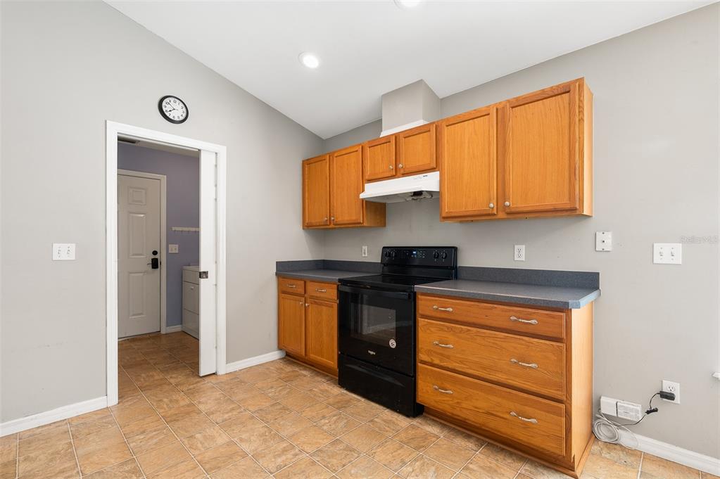 7462 Southwest 84th Drive Gainesville, FL 32608 - Photo 11 of 42 a kitchen with stainless steel appliances granite countertop a stove a sink and a refrigerator