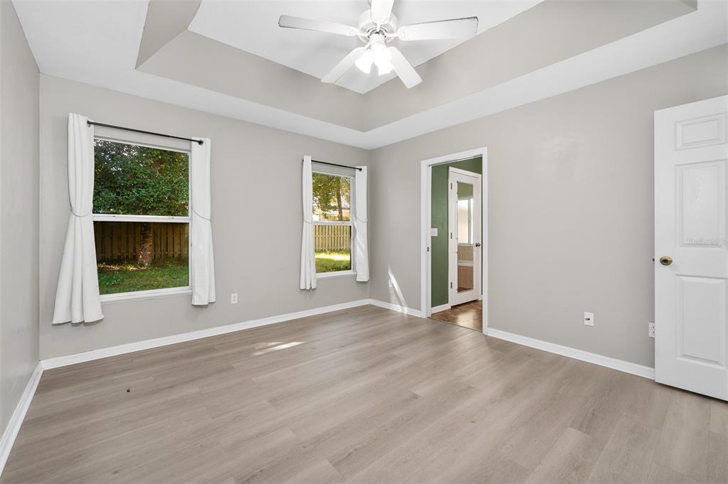 7462 Southwest 84th Drive Gainesville, FL 32608 - Photo 14 of 42 an empty room with wooden floor and windows
