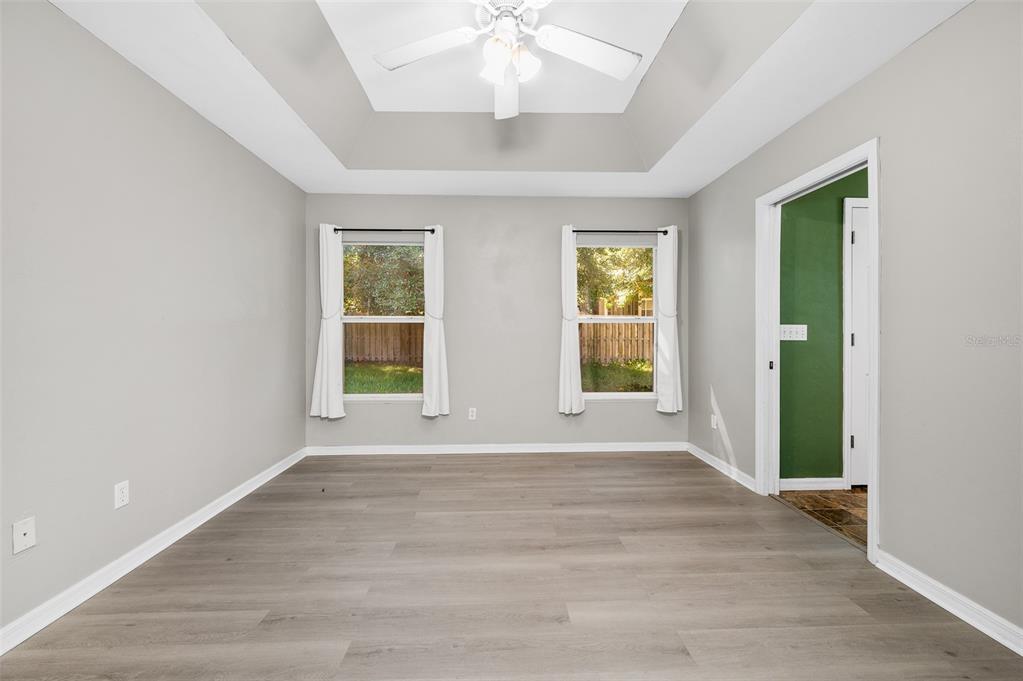 7462 Southwest 84th Drive Gainesville, FL 32608 - Photo 15 of 42 an empty room with wooden floor and windows